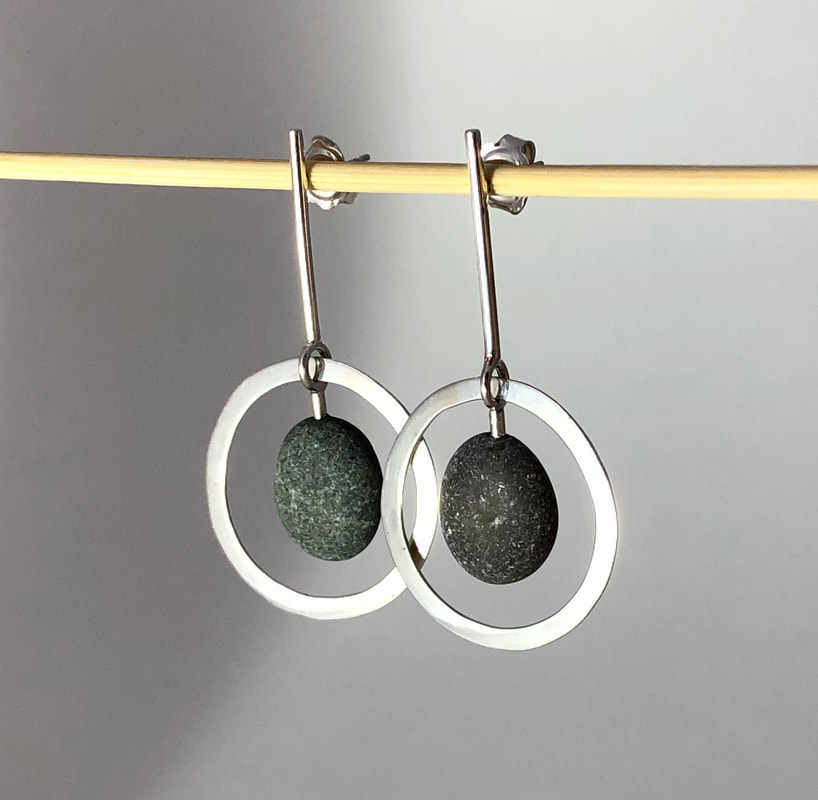 Pebble earrings made from New Zealand Greywacke and a large Sterling silver circle. The circles are suspended on a silver post  with stud fittings